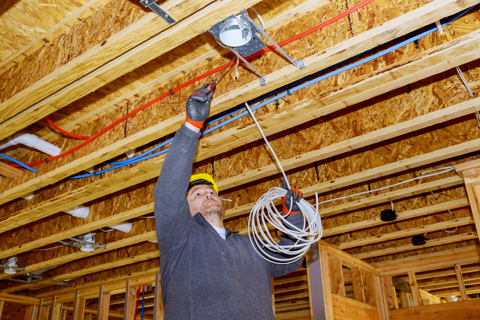 Process of installing electric wiring lights and ceiling in new home new home construction